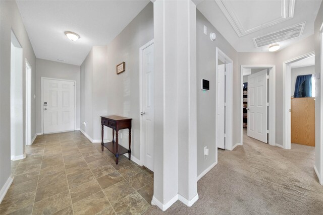 9924 Lace Flower Way, Conroe, TX 77385 - hallway featuring attic access, baseboards, and stone finish floors