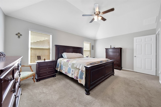 carpeted bedroom with ceiling fan and vaulted ceiling