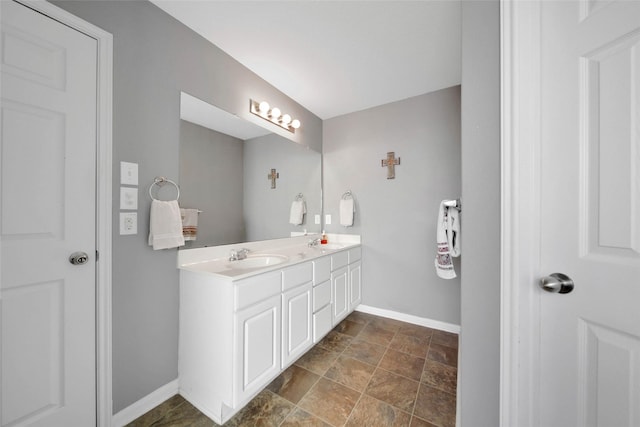 9924 Lace Flower Way, Conroe, TX 77385 - bathroom with baseboards, double vanity, and stone finish floors