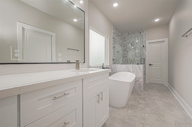 bathroom featuring vanity and independent shower and bath