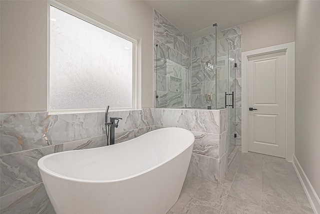 bathroom with tile walls and separate shower and tub