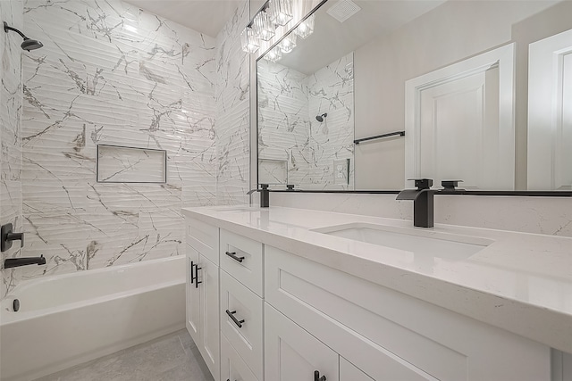 bathroom with vanity and tiled shower / bath