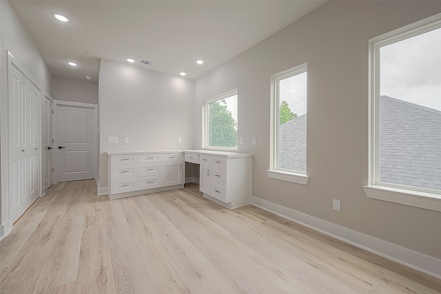 unfurnished office featuring light hardwood / wood-style floors