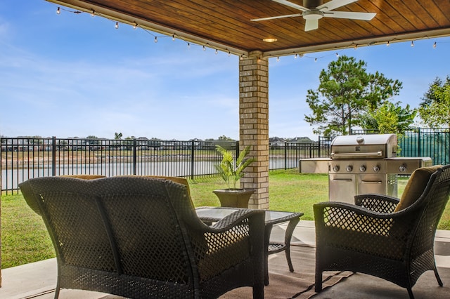 view of patio / terrace featuring grilling area, a water view, and ceiling fan