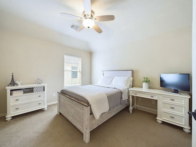 carpeted bedroom with ceiling fan and vaulted ceiling