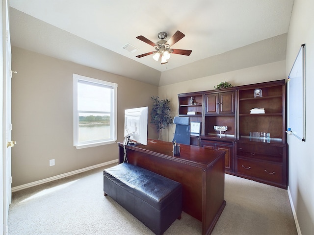 home office featuring light carpet, ceiling fan, and vaulted ceiling