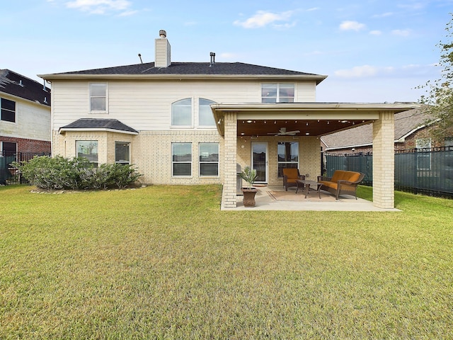 rear view of house featuring a lawn, ceiling fan, and a patio area