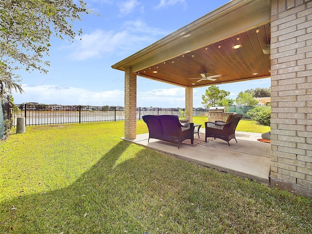 view of yard featuring a patio, a water view, an outdoor hangout area, and ceiling fan