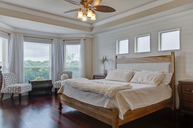 bedroom featuring dark wood-type flooring, ceiling fan, multiple windows, and wood walls