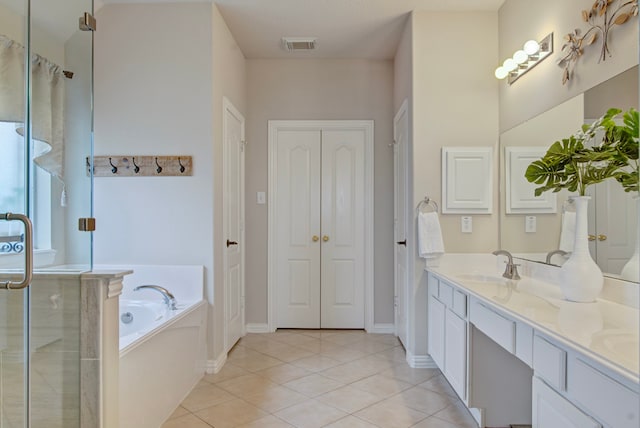 bathroom featuring vanity, shower with separate bathtub, and tile patterned flooring