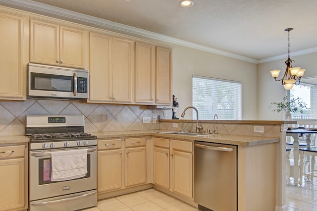 kitchen featuring stainless steel appliances, kitchen peninsula, light tile patterned floors, sink, and a chandelier