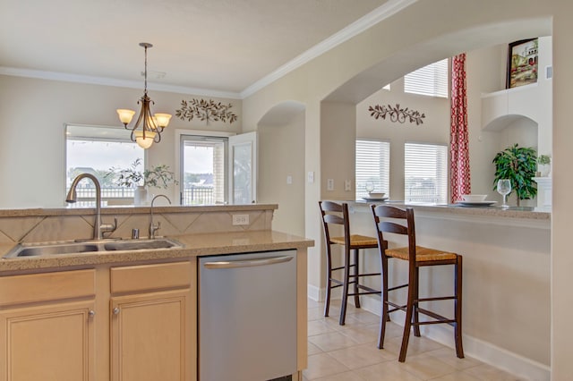 kitchen featuring sink, ornamental molding, light tile patterned floors, stainless steel dishwasher, and a chandelier