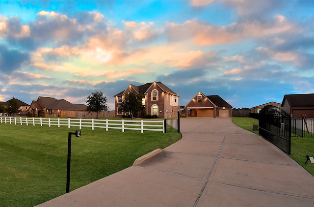 view of front of house with a yard and a garage