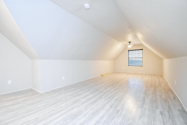 bonus room featuring vaulted ceiling and light wood-type flooring