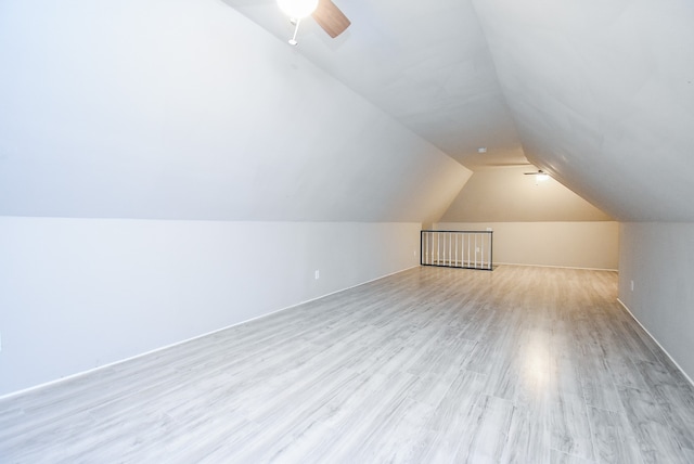 bonus room with light hardwood / wood-style floors and lofted ceiling