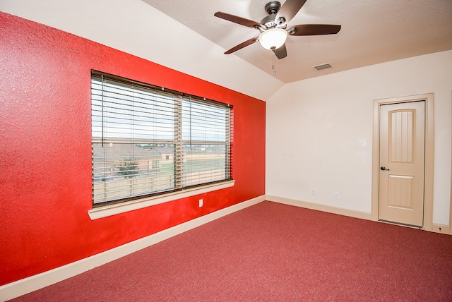 carpeted empty room with vaulted ceiling and ceiling fan