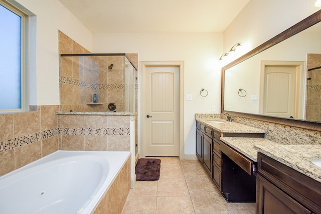 bathroom featuring vanity, plus walk in shower, and tile patterned flooring