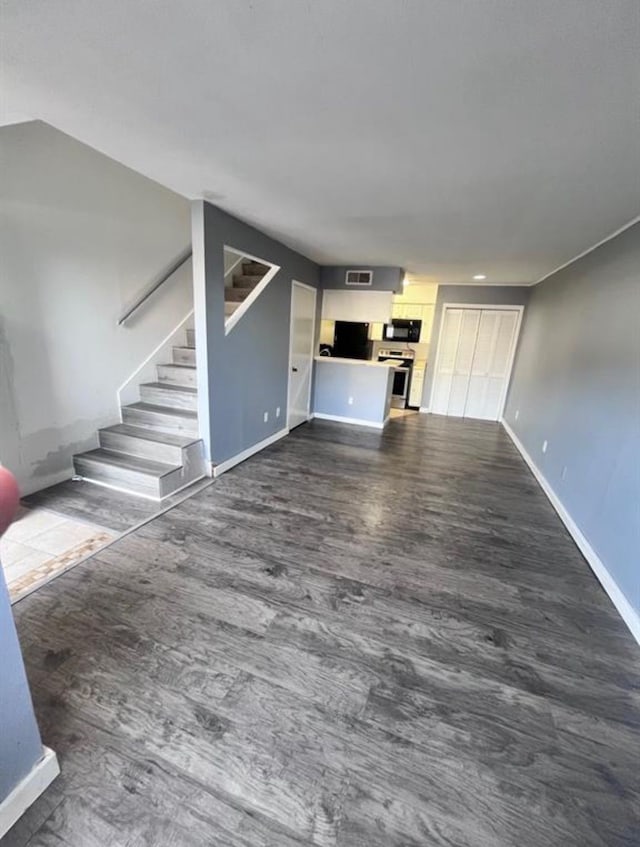 unfurnished living room with dark hardwood / wood-style floors