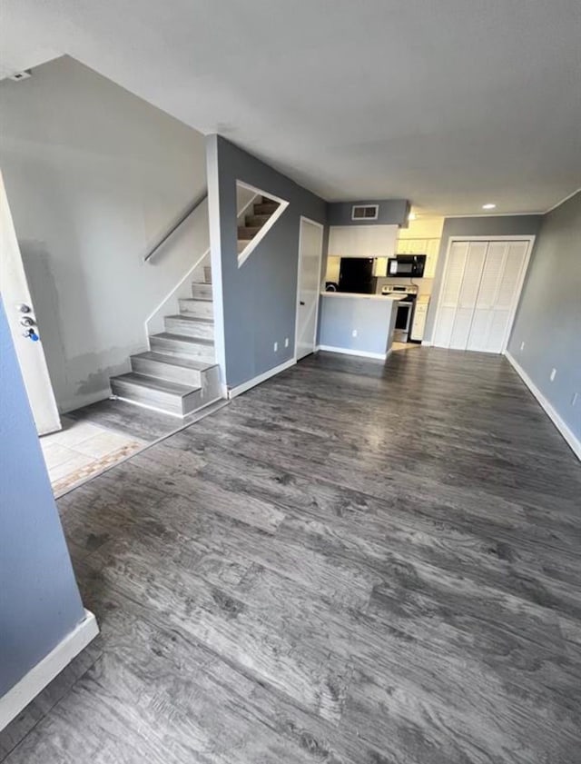 unfurnished living room with dark hardwood / wood-style floors