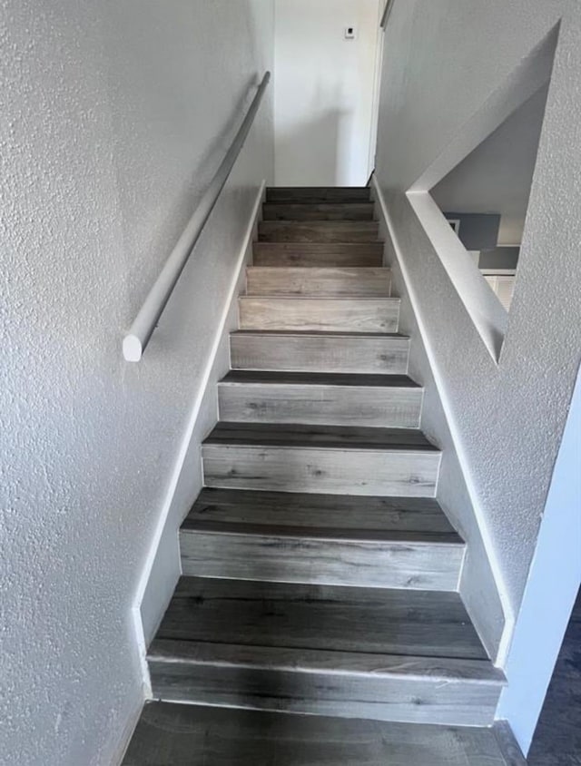 stairway with hardwood / wood-style floors