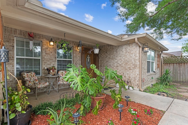 631 Apache St, Houston, TX 77022 - doorway to property with brick siding and covered porch