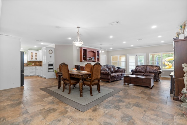631 Apache St, Houston, TX 77022 - dining space featuring ornamental molding, recessed lighting, and stone tile flooring