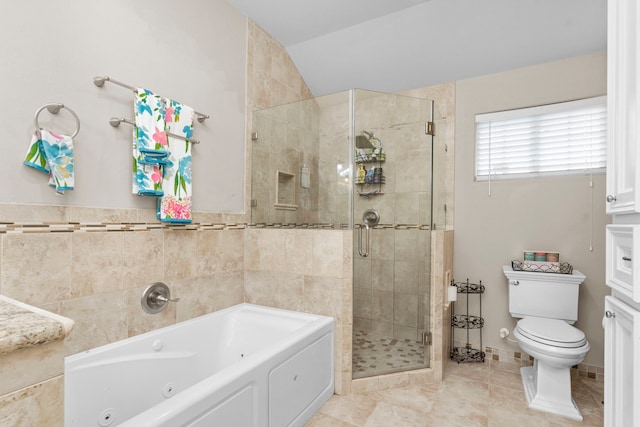 631 Apache St, Houston, TX 77022 - bathroom featuring a tub with jets, a stall shower, toilet, vaulted ceiling, and tile patterned flooring