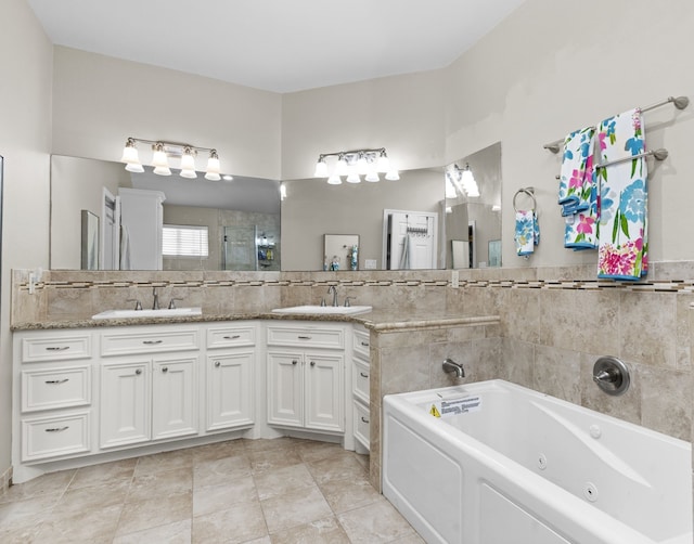 631 Apache St, Houston, TX 77022 - full bathroom featuring double vanity, a tub with jets, and tiled shower