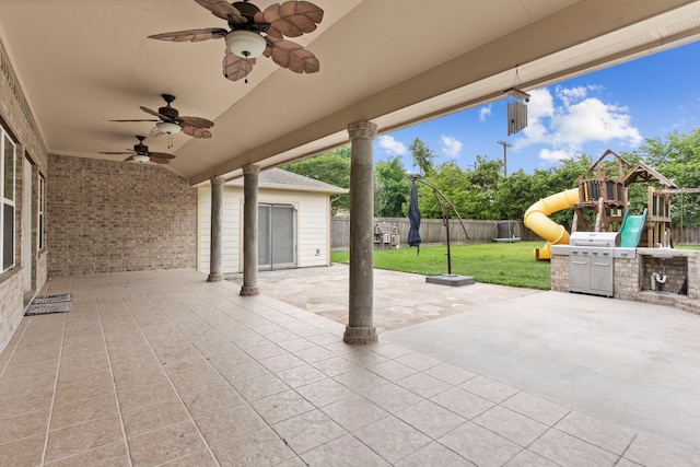 view of patio / terrace featuring ceiling fan and a playground