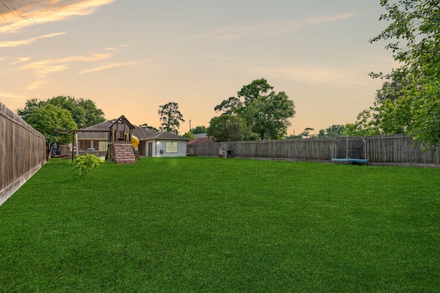 631 Apache St, Houston, TX 77022 - yard at dusk featuring a trampoline and stairway