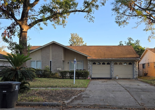 ranch-style home with a front yard and a garage