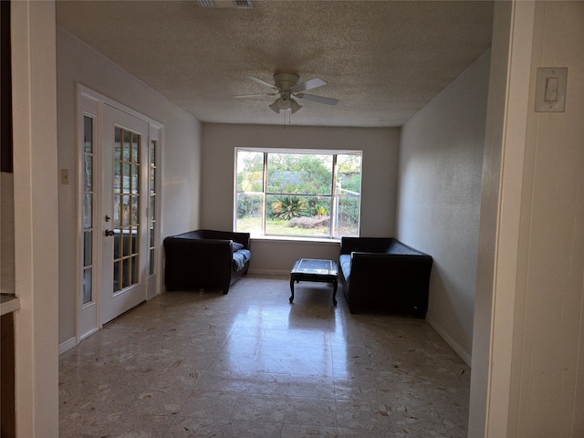 unfurnished room with a textured ceiling and ceiling fan