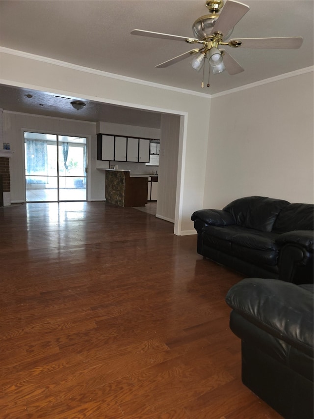 living room with crown molding, dark hardwood / wood-style floors, and ceiling fan