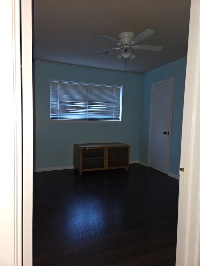 spare room with ceiling fan and wood-type flooring