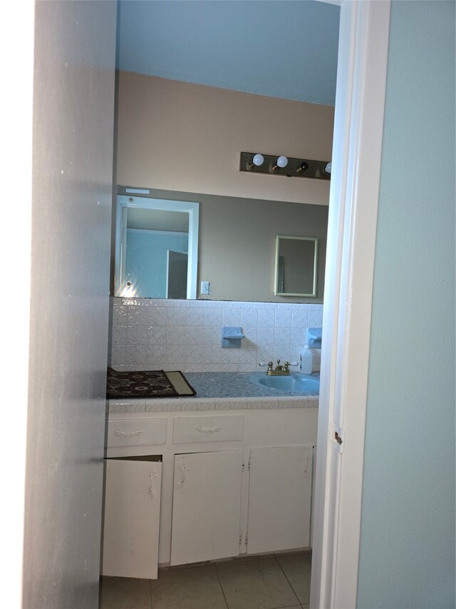 bathroom with vanity, tile patterned floors, and tasteful backsplash