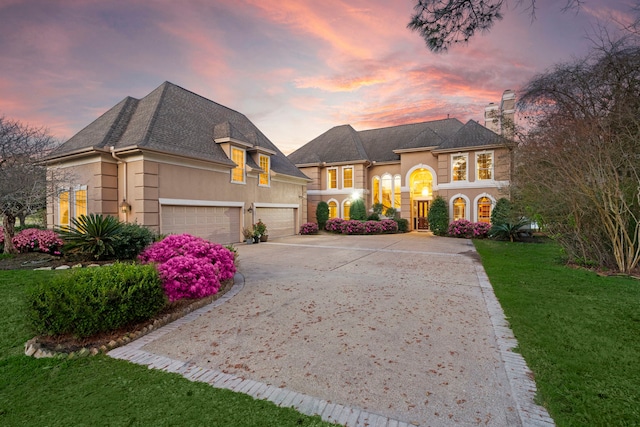 french country home featuring a yard and a garage