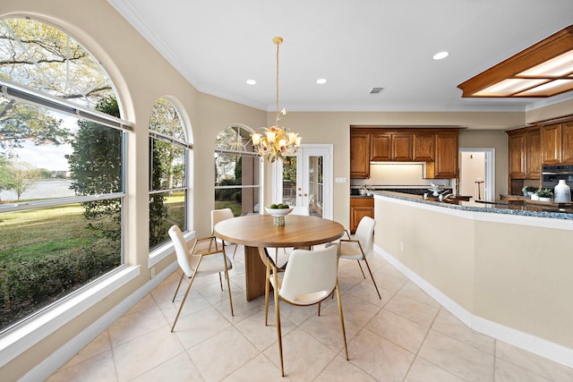 dining room with plenty of natural light, ornamental molding, recessed lighting, and an inviting chandelier