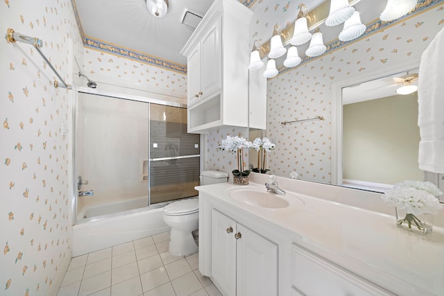 full bathroom featuring tile patterned floors, toilet, vanity, enclosed tub / shower combo, and ceiling fan