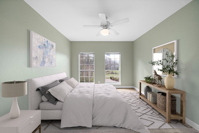 bedroom featuring ceiling fan and light carpet