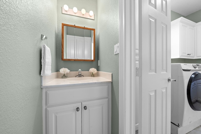 bathroom featuring washer / dryer and vanity