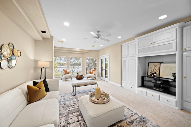 carpeted living room with ceiling fan