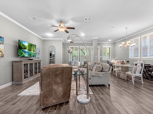 living room featuring hardwood / wood-style flooring, ceiling fan with notable chandelier, a textured ceiling, and ornamental molding