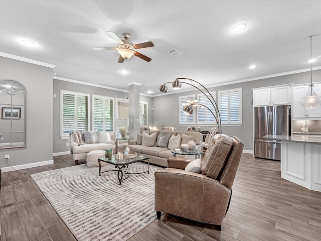 living room featuring ceiling fan, dark hardwood / wood-style floors, a textured ceiling, and crown molding