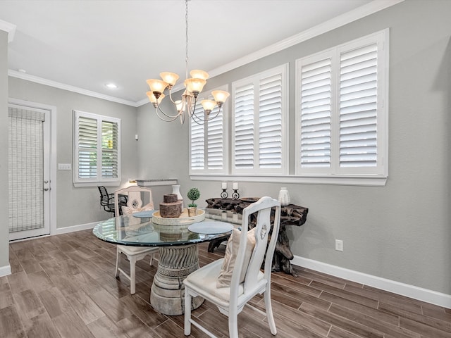 dining room with an inviting chandelier, wood-type flooring, and crown molding