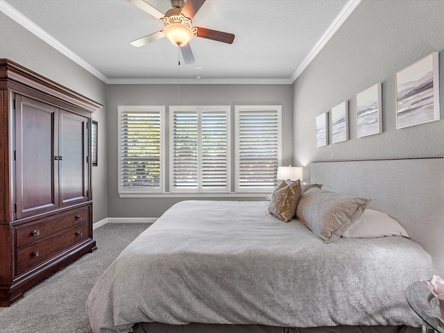 carpeted bedroom with a textured ceiling, ceiling fan, and crown molding