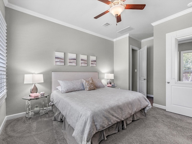 carpeted bedroom with ceiling fan and ornamental molding