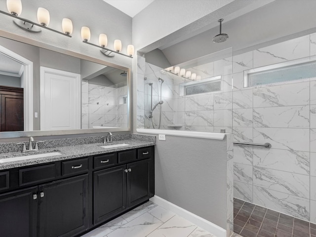 bathroom with vanity and tiled shower