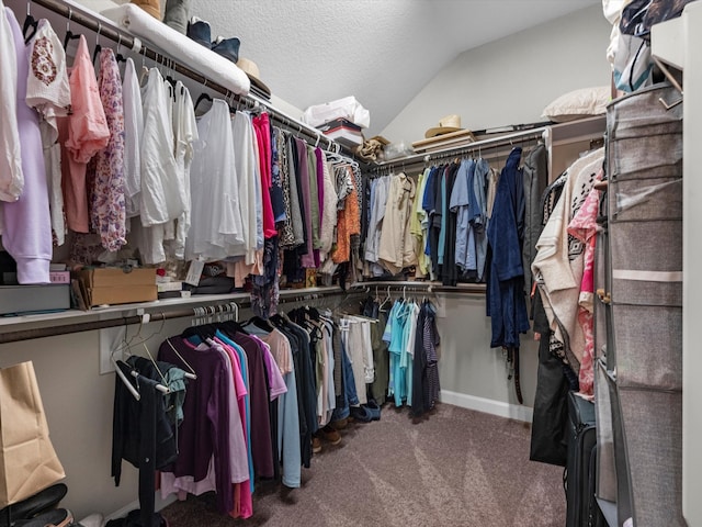 spacious closet featuring carpet floors and lofted ceiling