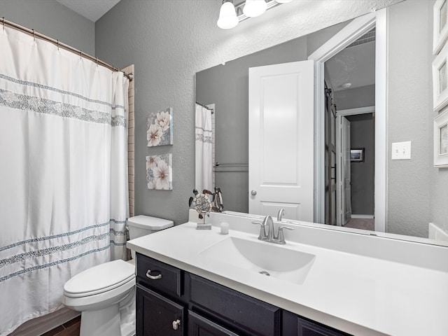 bathroom with hardwood / wood-style floors, curtained shower, vanity, and toilet