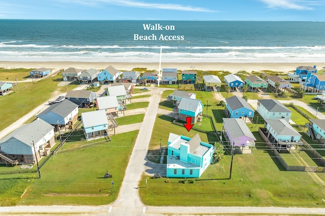 drone / aerial view featuring a view of the beach and a water view